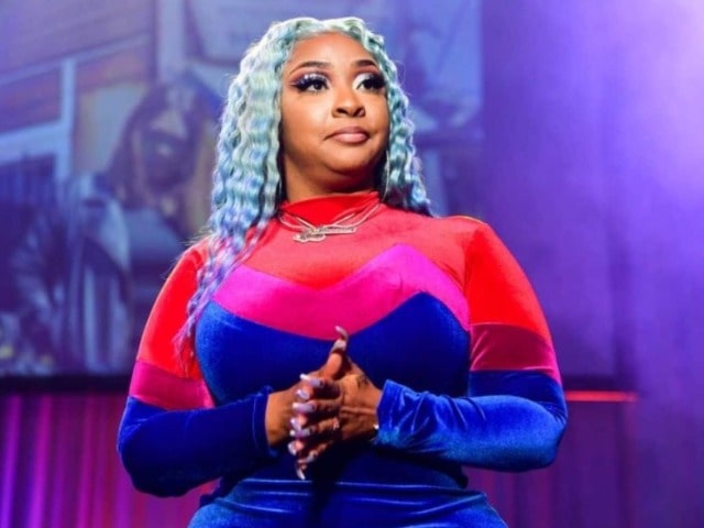 Photo of Jesseca Dupart wearing a mixed red, pink, and blue body cone.